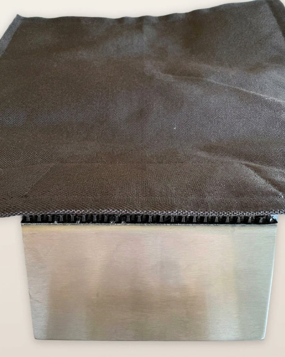 Close-up of the Clawstopper Cordura fabric panel and stainless steel J-channel clamp with grip strip